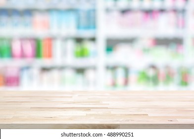 Empty Wood Counter Top On Blur Pharmacy Shelf (or Chemist And Cosmetic Shop) Background