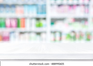 Empty Wood Counter Top On Blur Pharmacy Shelf (or Chemist And Cosmetic Shop) Background