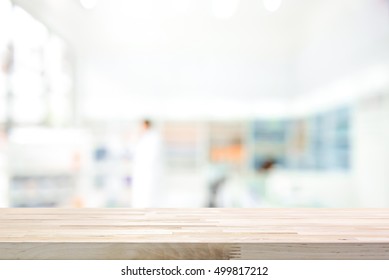 Empty Wood Counter Top On Blur Pharmacy (chemist Shop Or Drugstore) Background