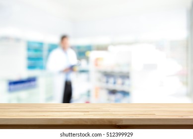 Empty Wood Counter Top On Blur Pharmacy (chemist Shop Or Drugstore) Background