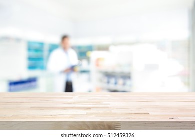 Empty Wood Counter Top On Blur Pharmacy (chemist Shop Or Drugstore) Background