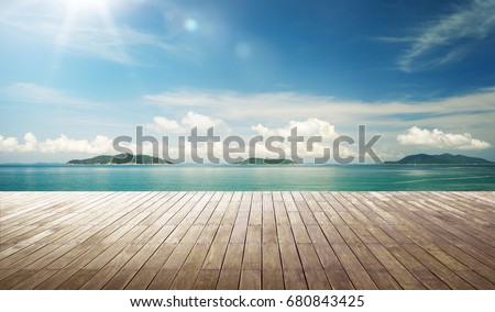 Empty wood jetty floor in front of beautiful afternoon seascape .
