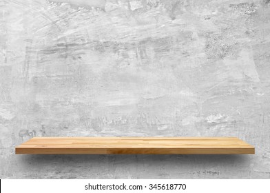 Empty wood shelf on bare concrete wall background - Shutterstock ID 345618770