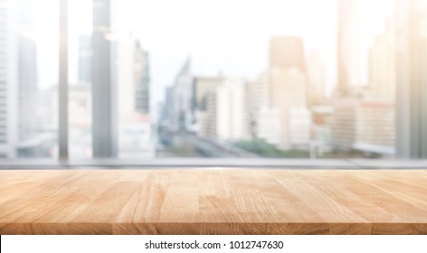 Empty Wood Table With Blur Room Office And Window City View Background.For Montage Product Display Or Design Key Visual Layout.