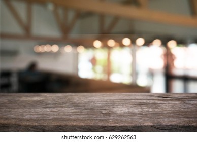 Empty wood table in front of abstract blurred background of coffee shop . can be used for display or montage your products.Mock up for display of product