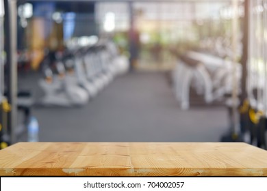 Empty Wood Table Space Platform And Fitness Gym Background. Product Display Montage Concept. 