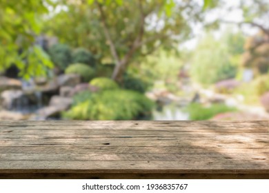 Empty Wood Table Top With Abstract Blur Park Garden Pond Background