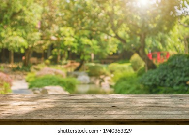 Empty Wood Table Top With Abstract Blur Park Garden Pond Background