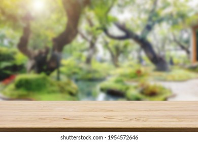 Empty Wood Table Top With Abstract Blur Park Garden Pond Background