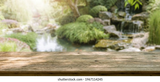 Empty Wood Table Top With Abstract Blur Park Garden Pond Background