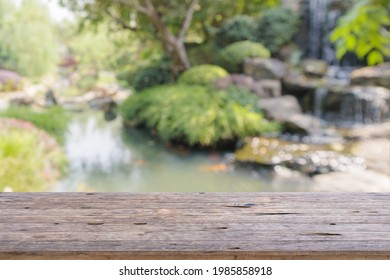 Empty Wood Table Top With Abstract Blur Park Garden Pond Background