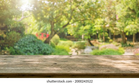 Empty Wood Table Top With Abstract Blur Park Garden Pond Background