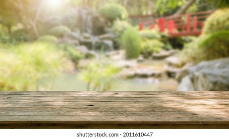 Empty Wood Table Top With Abstract Blur Park Garden Pond Background