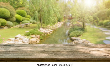 Empty Wood Table Top With Abstract Blur Park Garden Pond Background