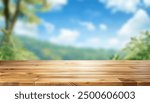 Empty wood table top with blur background of nature lush green forest. The table giving copy space for placing advertising product on the table a long with beautiful green forest nature background.