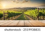 Empty wood table top with blur background of vineyard landscape in winery. The table giving copy space for placing advertising wine product on the table along with beautiful winery vineyard background