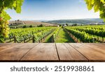 Empty wood table top with blur background of vineyard landscape in winery. The table giving copy space for placing advertising wine product on the table along with beautiful winery vineyard background