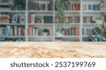 Empty wood table top with blur background of library at school or university. The table giving copy space for placing advertising product on the table along with beautiful library book background.