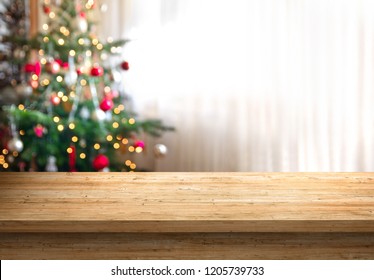 Empty Wood Table Top And Blur Of Room With A Christmas Tree Background, Suitable For Montage Product Display.