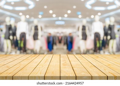 Empty Wood Table Top With Blur Clothing Boutique Display Interior Shopping Mall Background