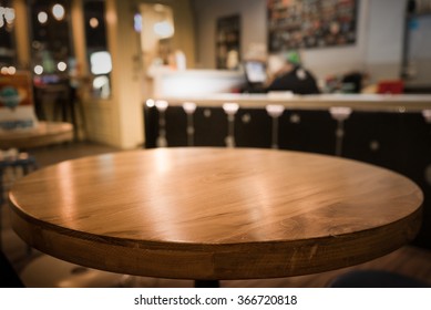 Empty Wood Table Top With Blur Of  Coffee Shop Or Cafe Restaurant Background.For Montage Product Display/ Selective Focus