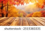 Empty wood table top and blurred autumn tree and red leaf background - can used for display or montage your products