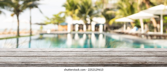 Empty wood table top and blurred summer beach bar in tropical resort banner background - can used for display or montage your products. - Powered by Shutterstock