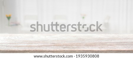 Empty wood table top and blurred coffee shop and restaurant interior background - can used for display or montage your products.