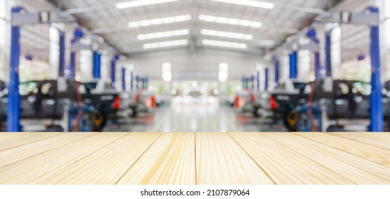 Empty Wood Table Top With Car Service Centre Auto Repair Workshop Blurred Background