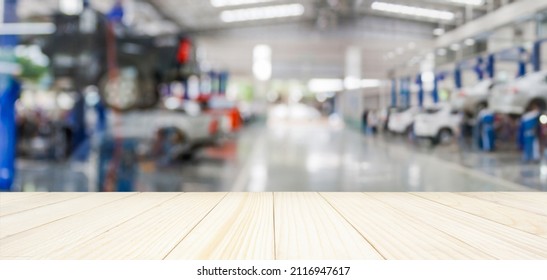 Empty Wood Table Top With Car Service Centre Auto Repair Workshop Blurred Background