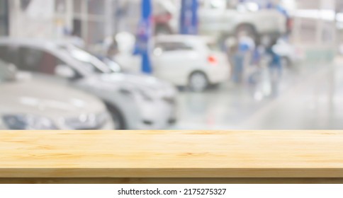 Empty Wood Table Top With Car Service Centre Auto Repair Workshop Blurred Background