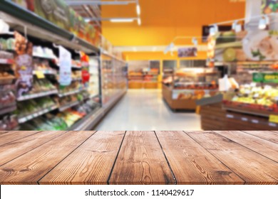 Empty wood table top on shelf in supermarket blurred background - Shutterstock ID 1140429617