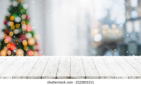 Empty wood table top on blur with bokeh Christmas tree and new's year decoration on window banner background with snowfall - can be used for display or montage your products. - Powered by Shutterstock