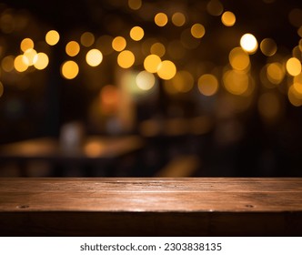 Empty wood table top on blur light gold bokeh of cafe restaurant