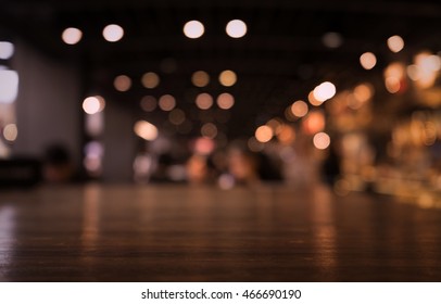 Empty Wood Table Top On Blur Light Gold Bokeh Of Cafe Restaurant In Dark Background/selective Focus .For Montage Product Display