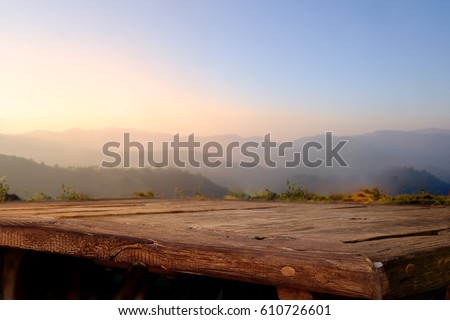 Empty wood table top on blur background of mountain. For display or montage your products.