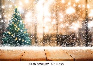 Empty Wood Table Top With Snowfall And Cafe Restaurant In Night Winter Background.For Holiday,christmas Day And New Year Concept.