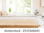 Empty wood table top view for product display montage on blur kitchen counter and wide window background