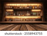 Empty wooden bar counter with defocused background and bottles of restaurant, bar or cafeteria background for your product display