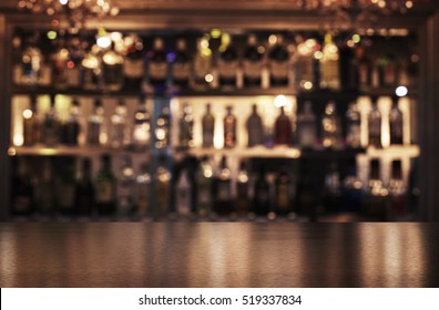 Empty wooden bar counter with defocused background of restaurant, bar or cafeteria and copy space - Shutterstock ID 519337834