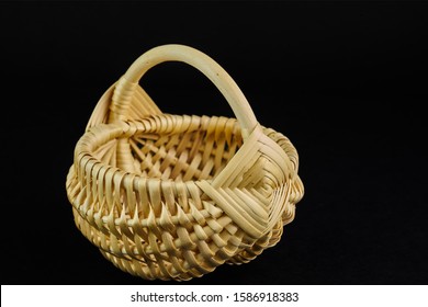 Empty wooden basket on black background