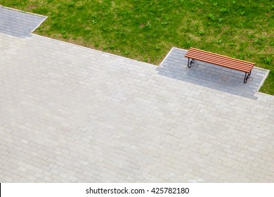 Empty Wooden Bench Stands In Summer Park Near Green Grass, Top View