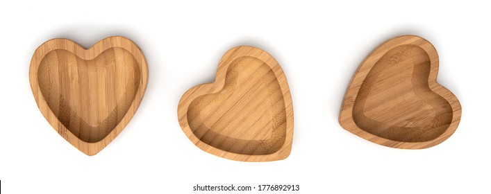 Empty wooden bowls in shape heart isolated on white background. Set of empty wood bowls for dry fruits and nuts . Collection. Top view.
