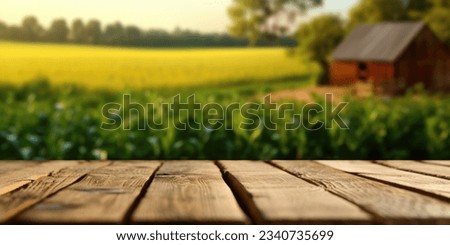 The empty wooden brown table top with blur background of farm and barn. Exuberant image.