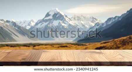 The empty wooden brown table top with blur background of Mount Cook landscape. Exuberant image.