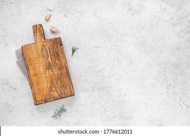 Empty Wooden Cutting Board With Napkin On White Stone Kitchen Table, Top View, Flat Lay. Wooden Platter, Copy Space.