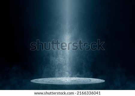 The empty wooden cylinder shape of product display Podium, Stand for showing or design blank backdrop dark abstract wall with smoke float up. Platform illuminated by spotlights