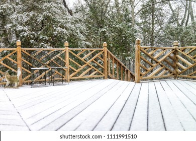 Empty Wooden Deck Of House With Statue Decorations, Chairs, Staircase Down On Backyard In Neighborhood With Snow Covered Wood Floor During Blizzard White Storm, Snowflakes Falling In Virginia Suburb