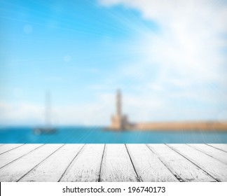 Empty wooden deck table with copyspace and bokeh background.