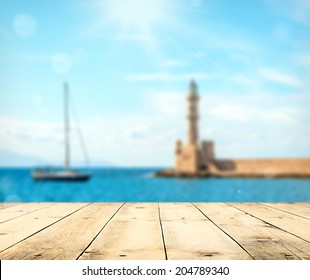 Empty wooden deck table with copyspace and bokeh travel background.